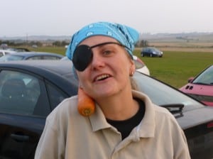 A confused trainee-pirate at the car boot sale with a carrot on her shoulder!